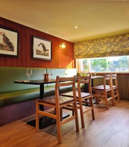 a dining room with wooden chairs and a table at The Alyth Hotel in Alyth