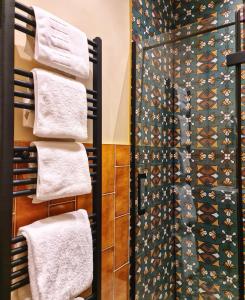 a bathroom with towels on a rack and a shower at The Alyth Hotel in Alyth