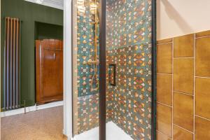 a bathroom with a wall covered in colorful tiles at The Alyth Hotel in Alyth