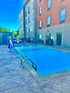 a swimming pool in front of a building at Holiday Inn Express & Suites Tulsa East - Catoosa, an IHG Hotel in Catoosa