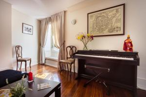 a living room filled with furniture and a piano at Old City Guest House in Braga