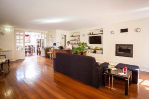 a living room with a couch and a person in the background at Old City Guest House in Braga