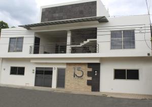 a white building with the number on it at 15 AVENIDA in Tapachula