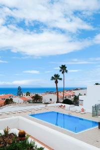 a swimming pool with a view of the ocean at MNG-Apart Aloha Garden Costa Adeje in Adeje