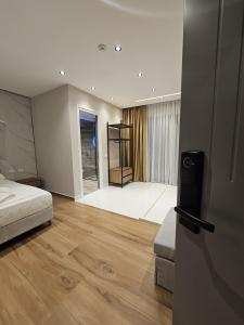 a bedroom with a bed and a room with a floor at Diol Hotel Ksamil in Ksamil