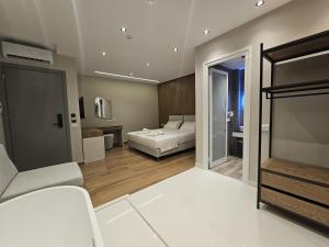 a bedroom with a bed and a living room at Diol Hotel Ksamil in Ksamil