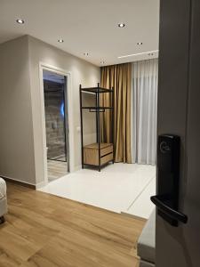 a living room with a room with a stair case at Diol Hotel Ksamil in Ksamil
