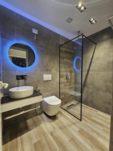 a bathroom with a toilet and a sink and a shower at Diol Hotel Ksamil in Ksamil