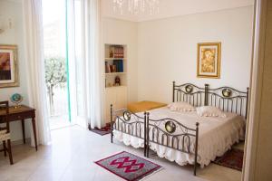a bedroom with a bed and a table and a window at Dimora Iride in Monopoli