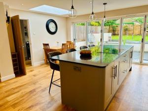 a kitchen with a large island with a counter top at Lanstone House in Chipping Norton