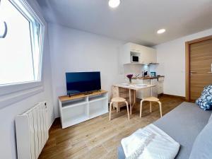 a bedroom with a bed and a desk with a television at Öspede Casa Totoia- Malpica de Bergantiños, Costa da Morte in Malpica