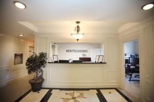 a lobby of an office with a reception counter at Montecassino Hotel & Suites in Toronto