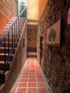 an alley with stairs and a stone wall at Hotel San Pancho in Real de Catorce