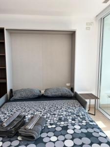 a bedroom with a large bed with towels on it at Eurosky Suite Apartment in Rome