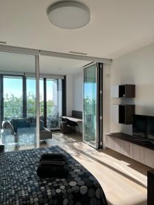 a bedroom with a large bed and a living room at Eurosky Suite Apartment in Rome