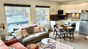 a living room with a couch and a table at Apres in Dinner Plain