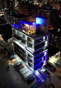 a tall building with blue lights on top of it at Apartamento próximo a praia no Tramonto bessa in João Pessoa