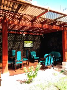 a group of chairs sitting under a pergola at Hotel Don Felipe Aeropuerto in Guatemala