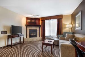 a living room with a couch and a fireplace at Best Western Strathmore Inn in Strathmore