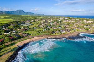 an aerial view of a beach with houses and the ocean at Aston At Poipu Kai in Koloa