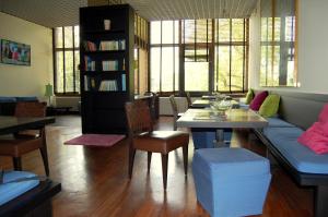 a living room with a couch and a table and chairs at Verdemilia Hotel in Anzola dell'Emilia