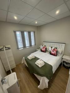 a hospital room with a bed with towels on it at Protea in Paarl