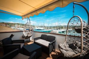 a balcony with chairs and swings on a boat at Floating Sea House Panther Superior in Portorož