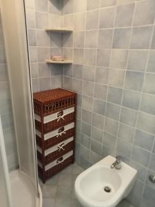 a bathroom with a sink and a toilet and a shower at Casetta Esmeralda in Praia a Mare