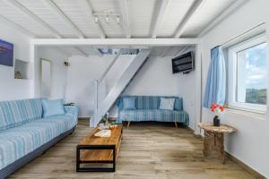 a living room with a couch and a table at The Mountain Majesty in Skopelos Town