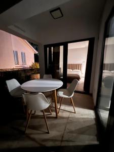 a table and chairs in a room with a bedroom at Casa Amor in Neum +10 photos