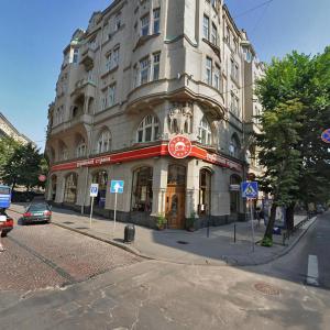 a large building on the corner of a street at Centrum Hostel in Lviv