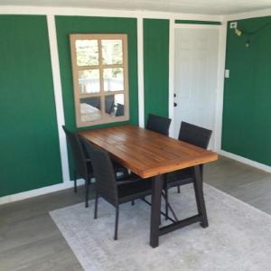 a wooden table and chairs in a room with green walls at Mystic Mountain Retreat in Miramonte +11 photos