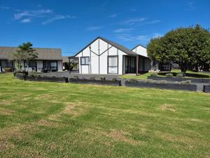 a house with a lawn in front of it at Magnolia Court Motel in Opotiki