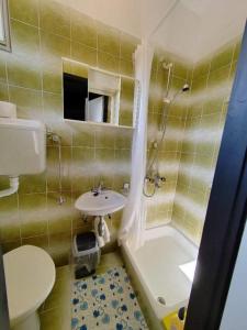 a bathroom with a sink and a toilet and a shower at Apartments with parking space Mundanije, Rab - 23299 in Rab +22 photos