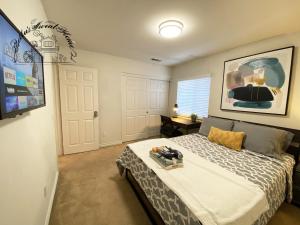 a bedroom with a large bed and a tv at Bella's sweet house 5640 in Eastvale