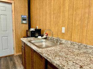 a kitchen with a sink and a counter top at Roberts Lodge in Tok