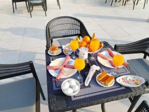 a table with a tray of food and orange juice at The Heaven Pyramids View in Cairo +40 photos