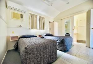 a hotel room with two beds in a room at country way motor inn in Cunnamulla