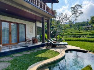 a house with a swimming pool next to a garden at Abian Ayu Villa in Sidemen