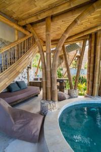 einen Pool in einem Haus mit Holzdecke in der Unterkunft Villa Grazia - Anima Eco Lodge -Ville Lussuose con Piscina Vista Mare in Selong Belanak