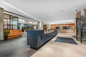 a lobby with a reception desk in a building at LeafIN Hotel Beijing Minzuyuan l Bird's Nest in Beijing
