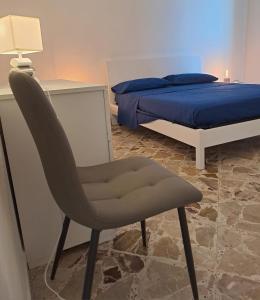 ein Schlafzimmer mit einem Stuhl neben einem Bett in der Unterkunft Residenza Paola in Palermo