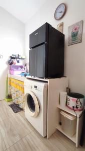 a washing machine with a tv on top of it at Olango Transient Home,with WIFI &Netfix in Santa Rosa +25 photos