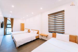 Postel nebo postele na pokoji v ubytování Epic Đồng Văn Hotel + 35 fotografií