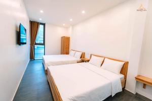 Postel nebo postele na pokoji v ubytování Epic Đồng Văn Hotel