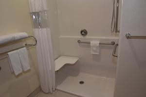 a bathroom with a shower and a tub and a toilet at Home Away Kitchen Suites Enid in Enid
