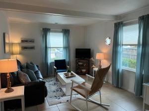 a living room with a couch and a table at Absolute Beach 4bedrooms-3bath steps to beach in Virginia Beach