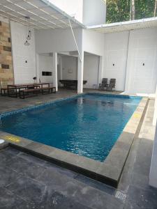 a swimming pool with blue water in a building at Villa Estate 43 New in Batu