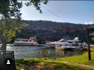 three boats are docked in the water at a marina at Casa flor de Mandacaru in Piranhas