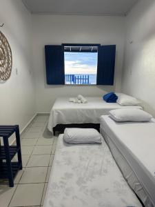 Un pat sau paturi într-o cameră la Casa Pé na Areia